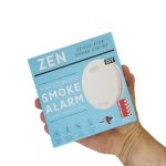 ZEN photoelectric smoke alarm 1-pack being held by a hand - close up image