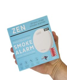 ZEN photoelectric smoke alarm 1-pack being held by a hand - close up image