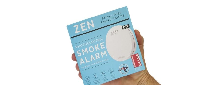 ZEN photoelectric smoke alarm 1-pack being held by a hand - close up image